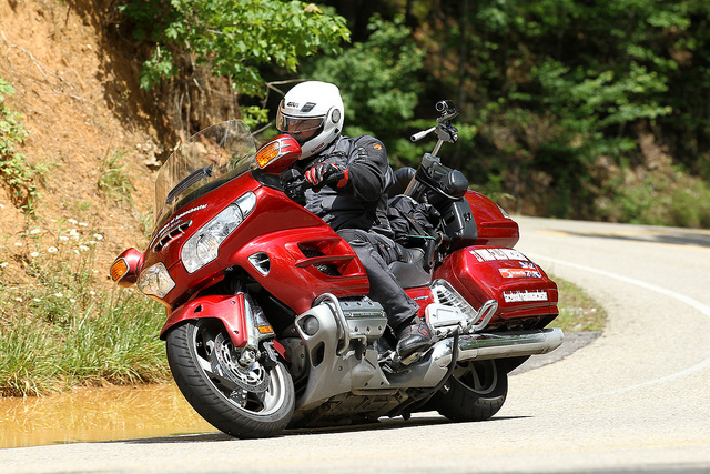 Red Honda Goldwing riding round corner