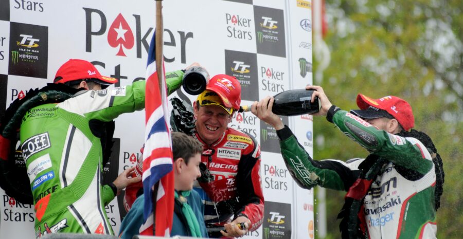 John McGuinness getting doused in champagne on the podium