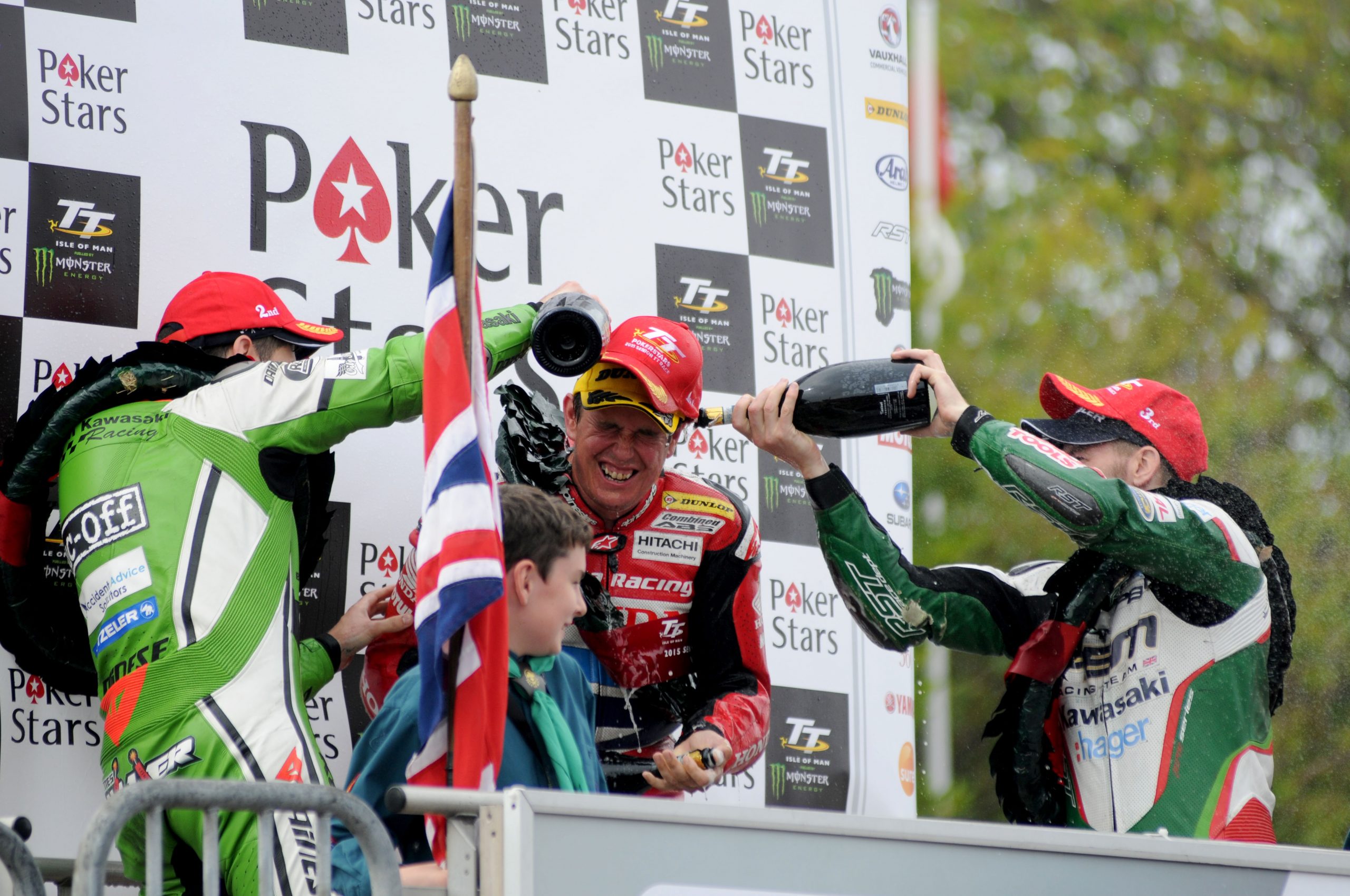 John McGuinness getting doused in Champagne on the podium