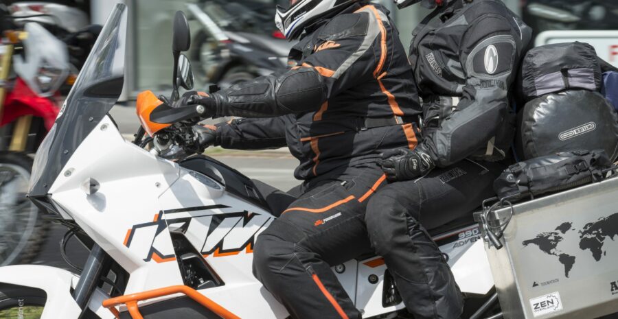 Two people on a KTM motorcycle