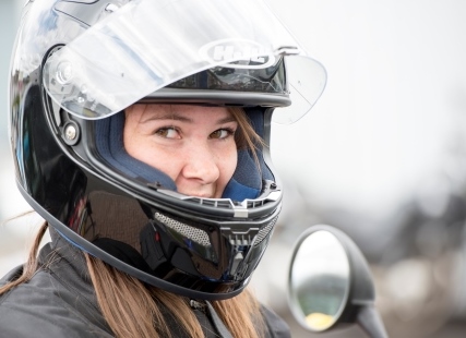 Woman wearing motorcycle helmet