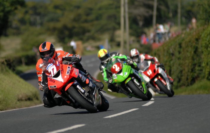 PACEMAKER PRESS BELFAST 14/08/10 - Ryan Farquhar on his KMR Kawasaki leads Ian Lougher and Gary Johnson at Joey's Windmill while on the way to third in the Superstock race at the Ulster Grand Pric