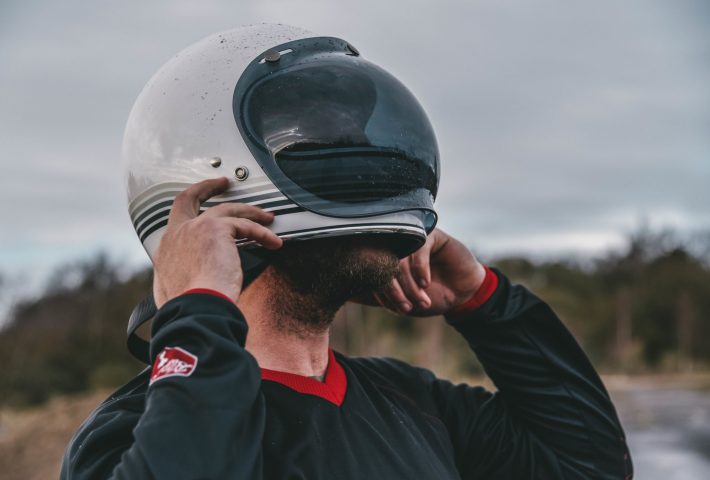 Biker putting on their helmet credit devitt/rolling rouges 