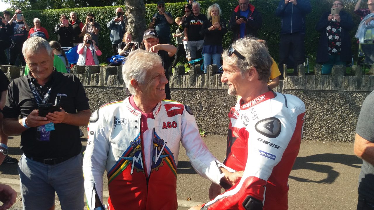 Giacomo Agostini with Carl Fogarty chatting at the Classic TT