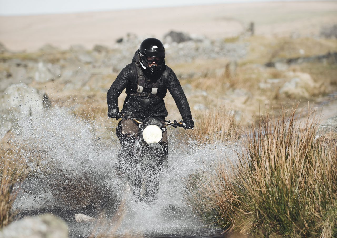 Biker riding through puddle