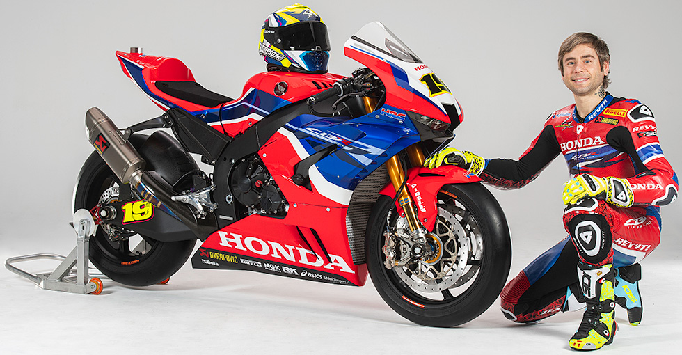 Alvaro Bautista posing next to a Honda race bike